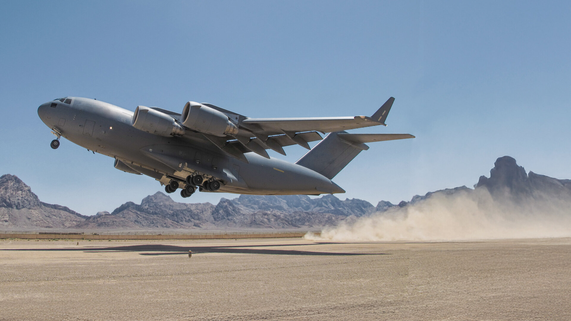 globemaster taking off on dry lake bed